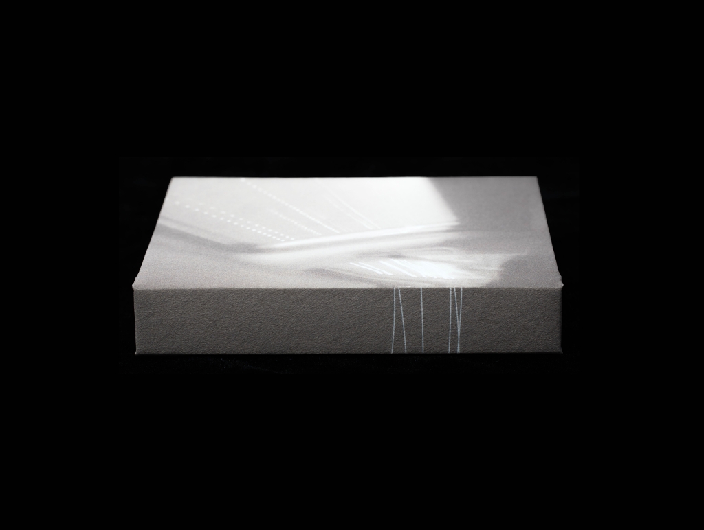 Open artist book with archival photographs